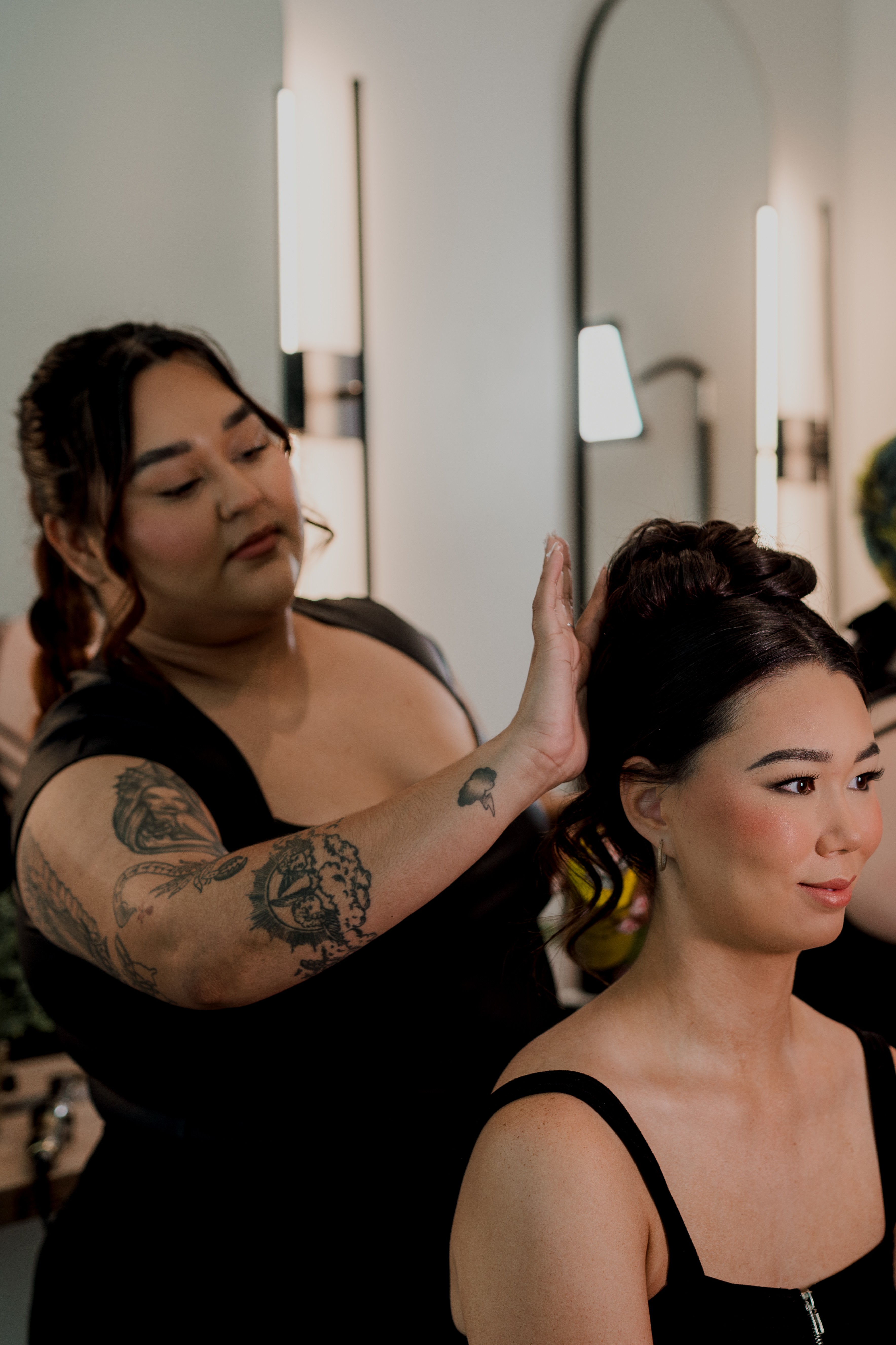 Hair and makeup team working together on a client’s look.