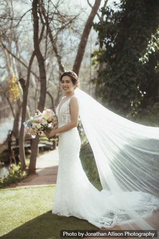Bride with a cathedral veil outdoors