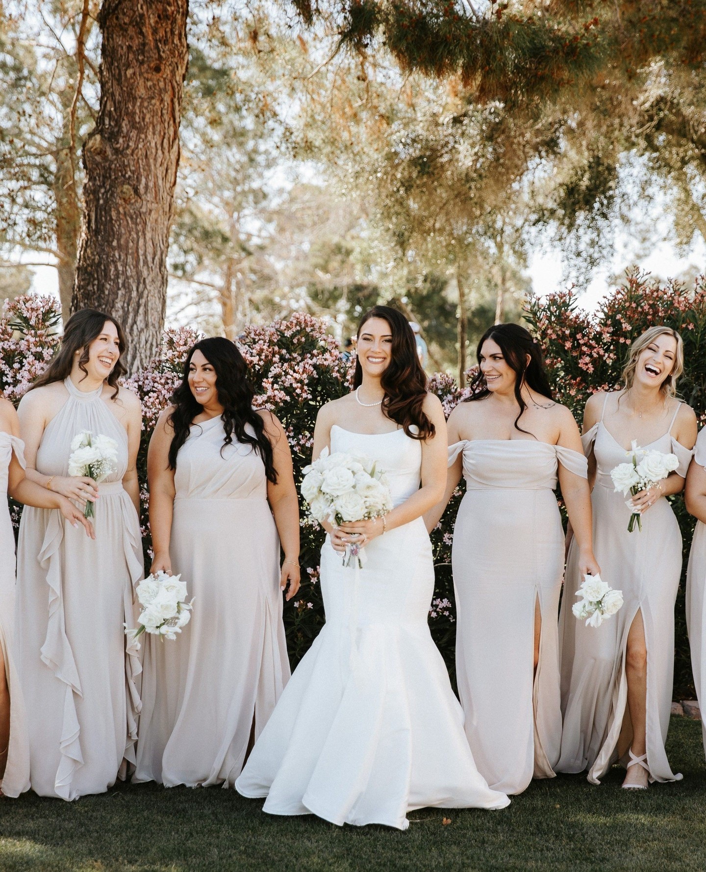 A bride in the ÉLYSÉE GALATEA gown with her bridesmaids, featured by ÉLYSÉE Bridal.